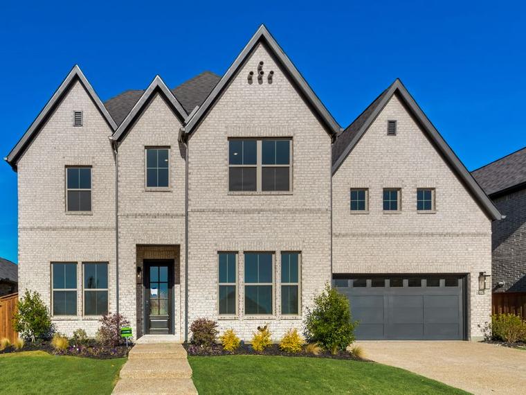 Painted brick new construction home with steep gables in North Texas