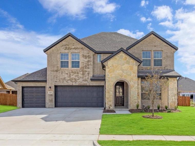 New construction home with a three-car garage and stone accents in North Texas